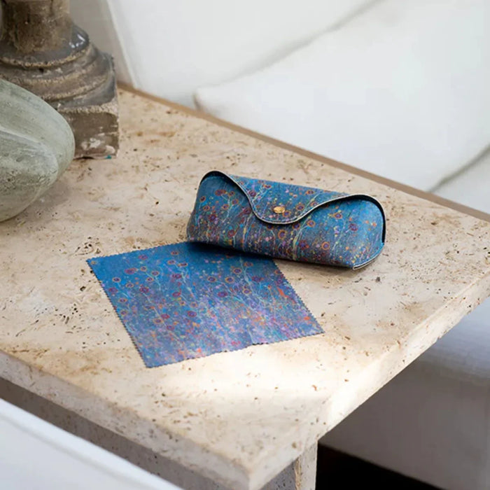 Blue patterned pouch and mat on a textured surface