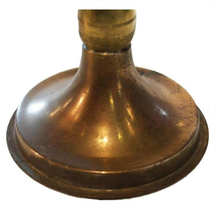 Close-up of antique brass oil lamp base with wide, rounded bottom, showing vintage brass finish.