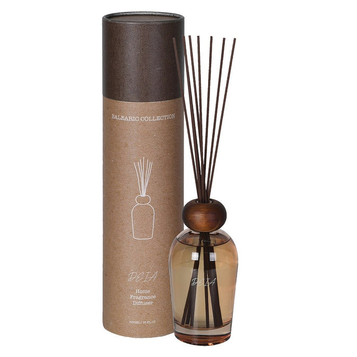 Diffuser with wooden bead and reeds next to a cylindrical packaging on a white background