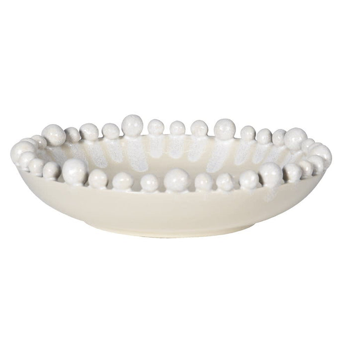 Decorative bowl with bead-like embellishments on a white background
