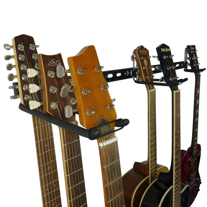 Wall-mounted guitar rack holding multiple acoustic and electric guitars