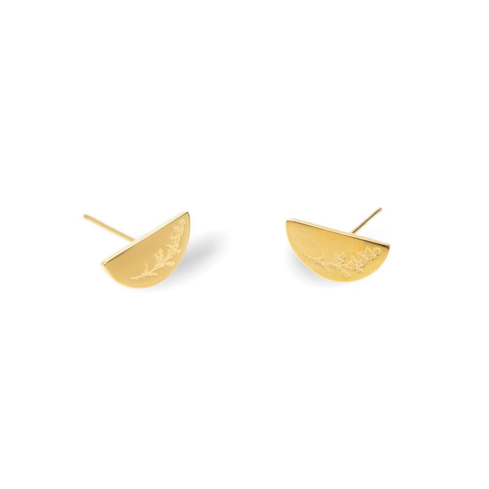 Gold half-circle earrings with leaf details on a white background