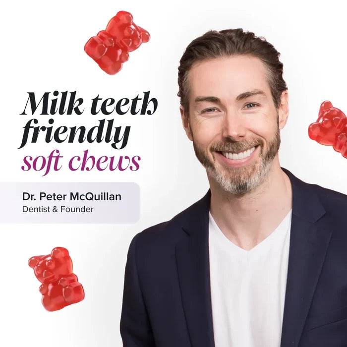 Dr Peter McQuillan, dentist and founder, smiling in a navy blazer on a white background with floating red gummy bears, beside the text 'Milk teeth friendly soft chews'.