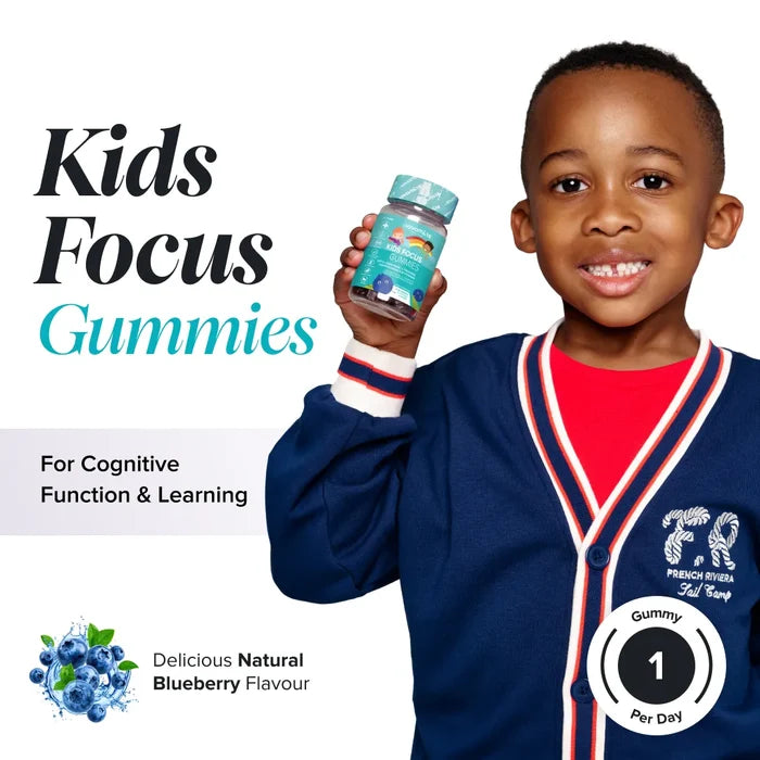A smiling boy in a navy cardigan holds a bottle of Novomins Kids Focus Gummies, headed 'Kids Focus Gummies for cognitive function & learning', in a natural blueberry flavour with one gummy per day.
