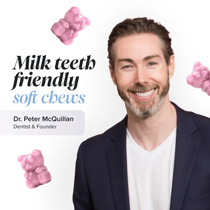 Dr Peter McQuillan, dentist and founder, smiling in a navy blazer on a white background with floating pink gummy bears, beside the text 'Milk teeth friendly soft chews'.