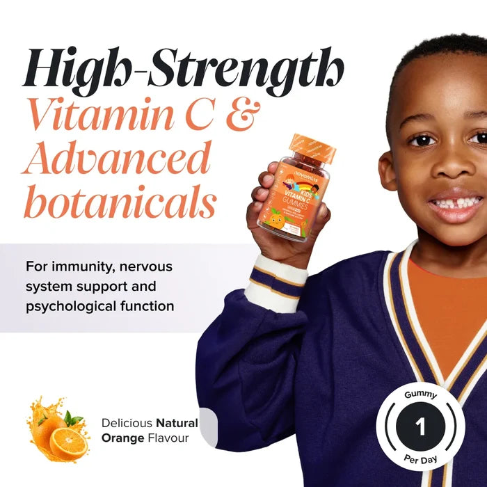 A smiling boy in a navy cardigan holds a bottle of Novomins Kids Vitamin C Gummies, headed 'High-Strength Vitamin C & Advanced botanicals for immunity, nervous system support and psychological function', in a natural orange flavour with one gummy per day.
