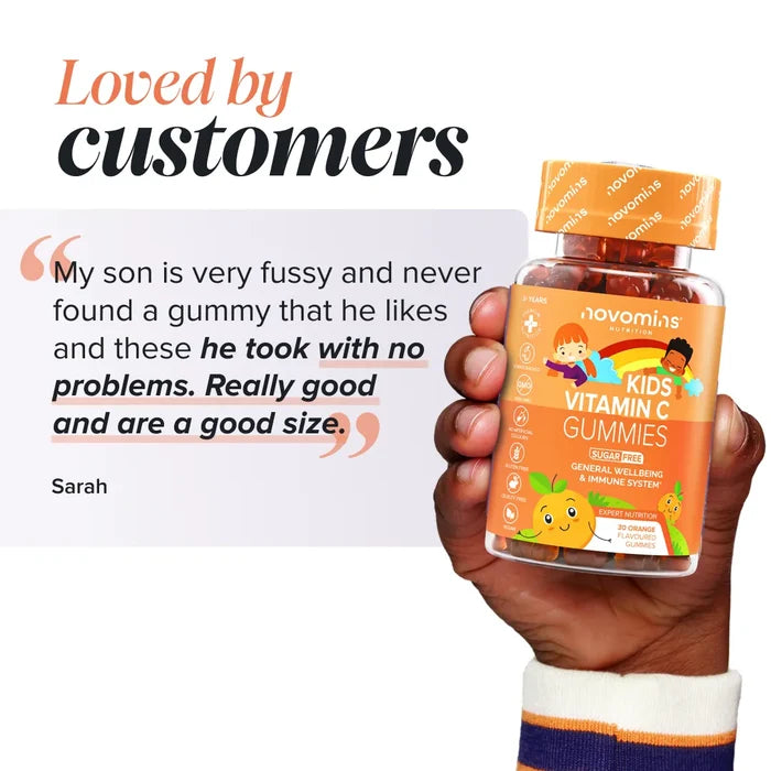 A hand holding a bottle of Novomins Kids Vitamin C Gummies beside a review from Sarah headed 'Loved by customers': 'My son is very fussy and never found a gummy that he likes and these he took with no problems. Really good and are a good size.'
