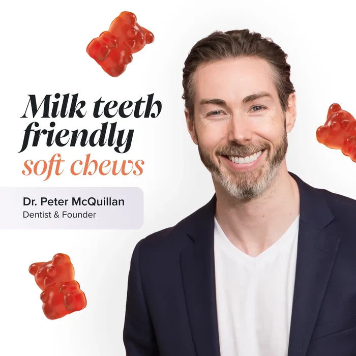 Dr Peter McQuillan, dentist and founder, smiling in a navy blazer on a white background with floating orange-red gummy bears, beside the text 'Milk teeth friendly soft chews'.