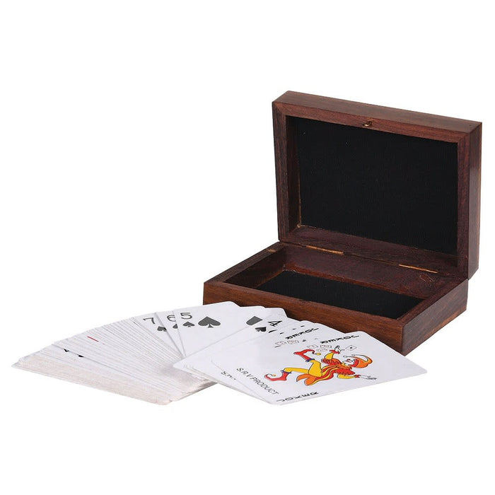 A wooden card box with an open lid and a small spread of playing cards in front, photographed on a plain white background.