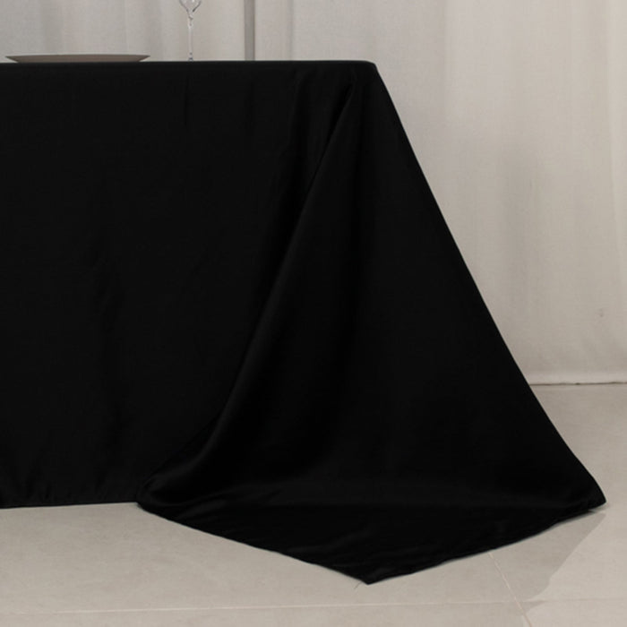 Black tablecloth draped elegantly on a table in a minimalist setting.