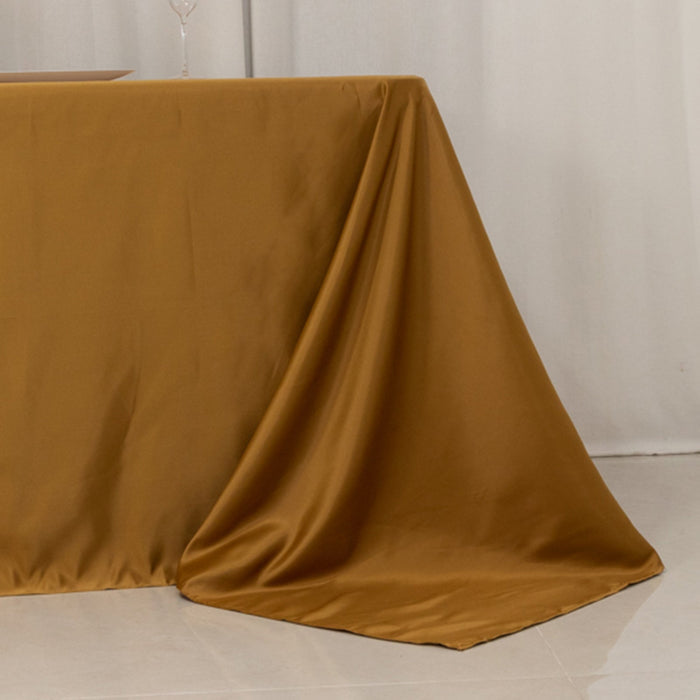 Brown satin tablecloth draping elegantly over a table edge.