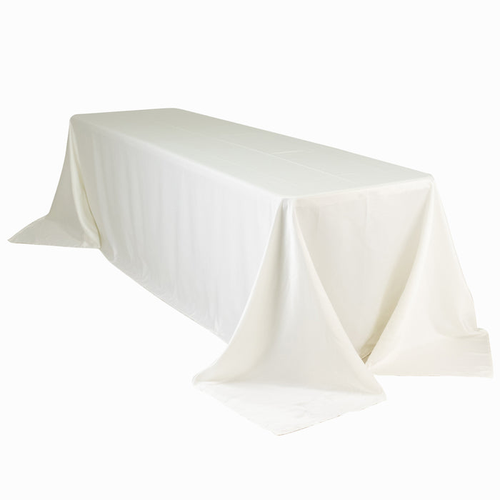 White tablecloth draped over a long table, showcasing smooth fabric texture.