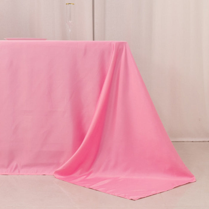 Pink tablecloth draping elegantly over a table in a soft setting.