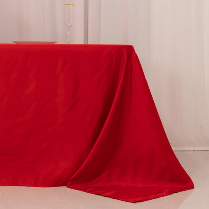 Red tablecloth draped elegantly over a table in a soft setting.