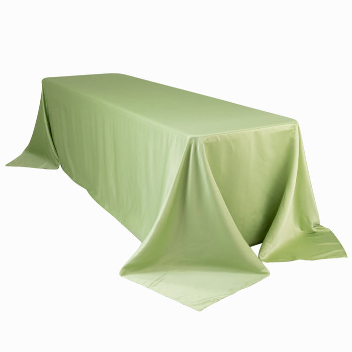 Green tablecloth draped over a rectangular table on a plain background.