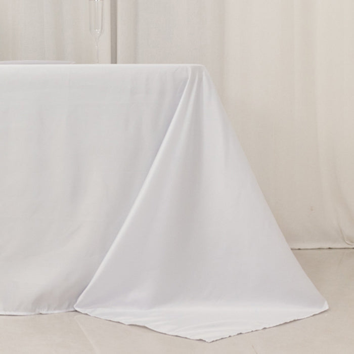 White tablecloth draping elegantly over a table in a studio setting.