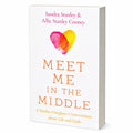 Book cover for 'Meet Me in the Middle' by Sandra Stanley & Allie Stanley Cooney, featuring a white background with a pink and yellow heart graphic and orange title text.