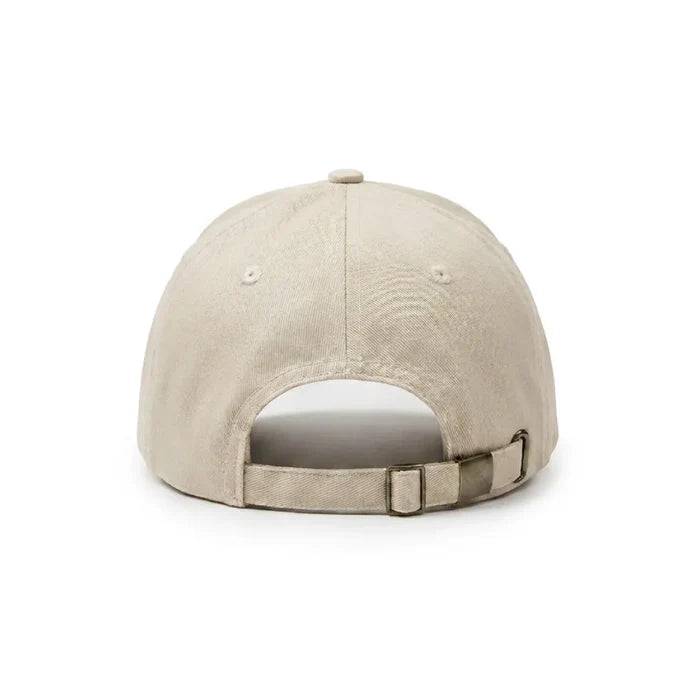Back view of a cream Novomins baseball cap on a white background, showing the metal buckle adjuster strap.