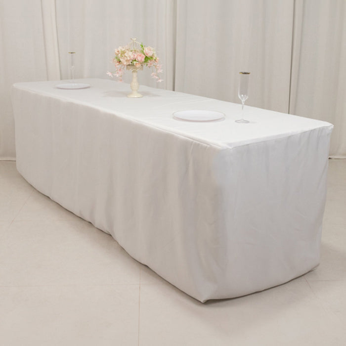 Elegant white table with a floral centerpiece and glassware.