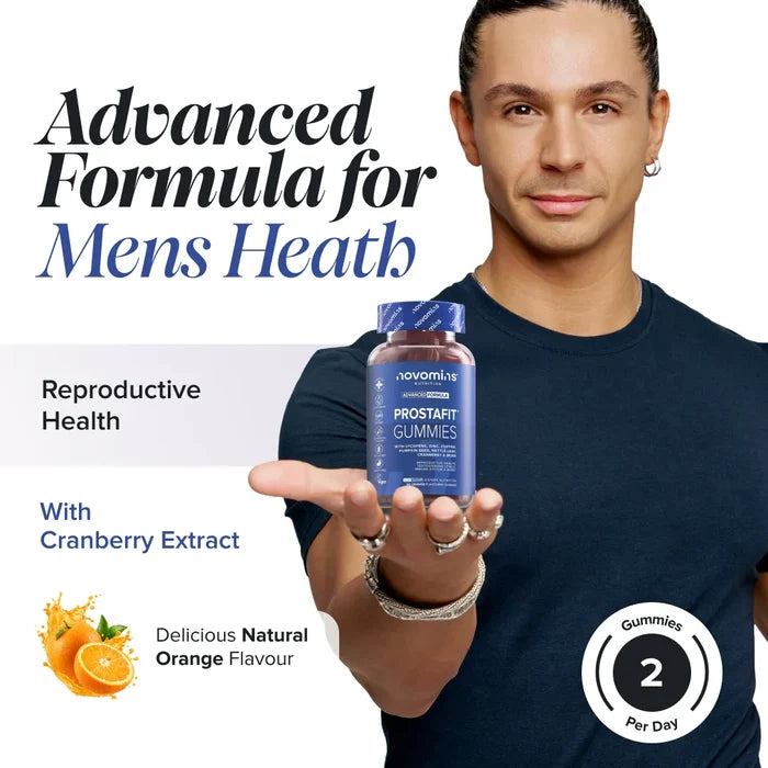 A smiling man in a navy t-shirt holds out a bottle of Novomins ProstaFit Gummies, headed 'Advanced Formula for Men's Health' with reproductive health support and cranberry extract, in a natural orange flavour with two gummies per day.