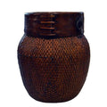 Close-up of natural woven bamboo Thai grain basket with dark wooden rim and decorative stitching, isolated on white background.