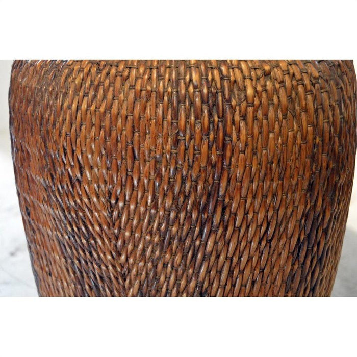 Close-up of brown rattan Thai grain basket with tightly woven, textured pattern.
