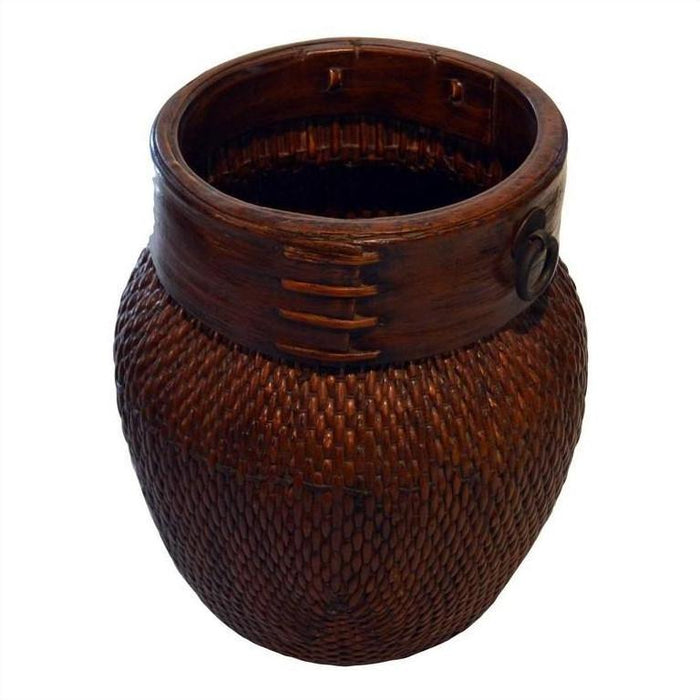 Close-up of large brown wicker Thai grain basket with smooth wooden rim and decorative stitching.