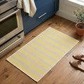 Yellow striped rug on a wooden floor in a kitchen setting